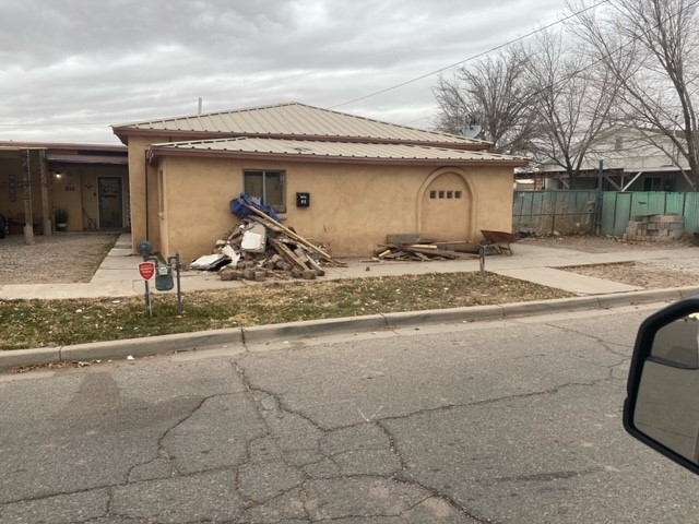 Before home front piled with debris