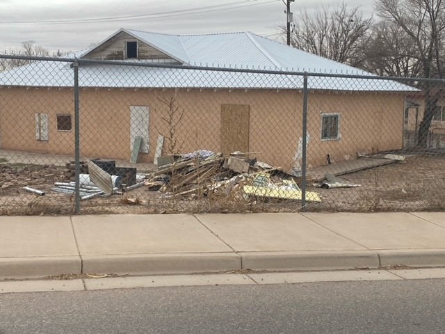 Before home yard piled with debris